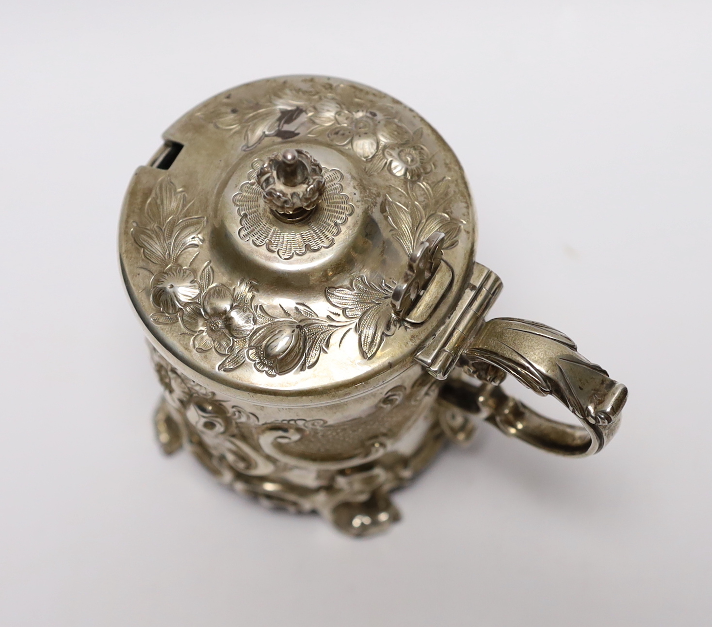 A Victorian embossed silver drum mustard, John Evans II, London, 1863, decorated with foliage and scrolls.